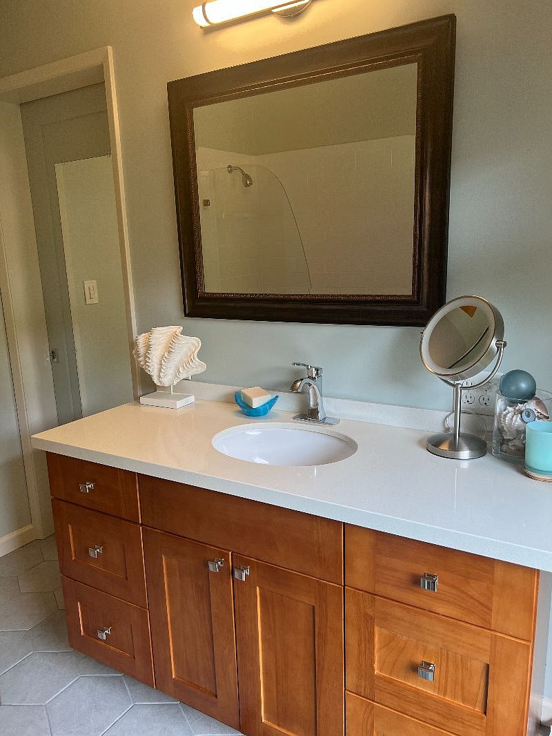 primary bath attached to primary bedroom and hallway access for guests