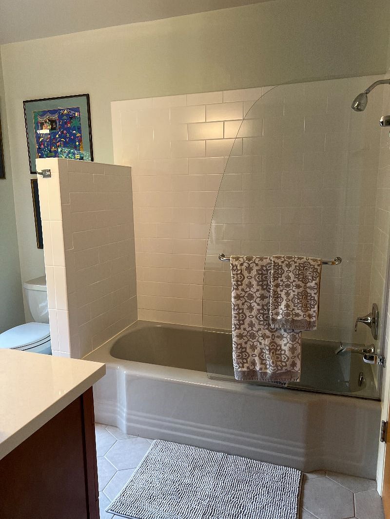 primary bath attached to primary bedroom and hallway access for guests