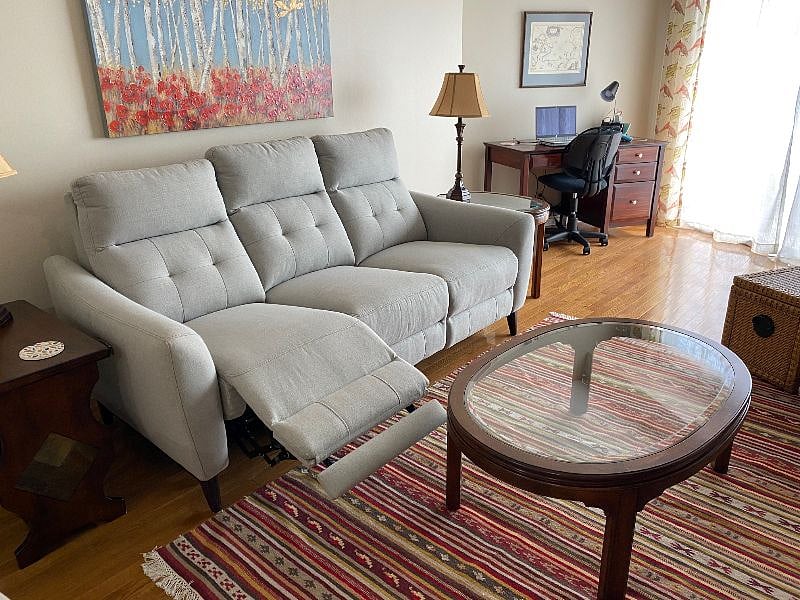 The condo furnishings focus on comfort, including a reclining sofa.