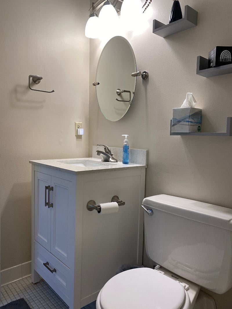 The bathroom is small but efficient with storage and updated features.