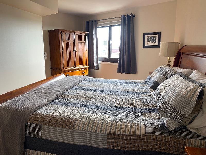 With a closet and large cabinet, there's good space for clothes storage.