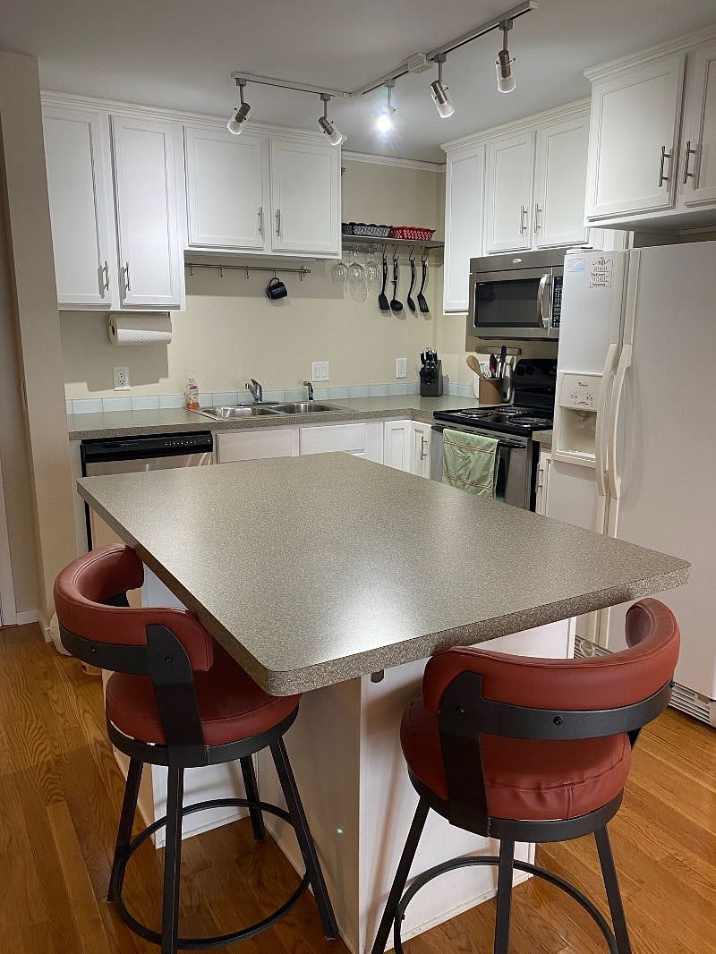 The kitchen is well-appointed and feature dining stools with backs for added comfort.