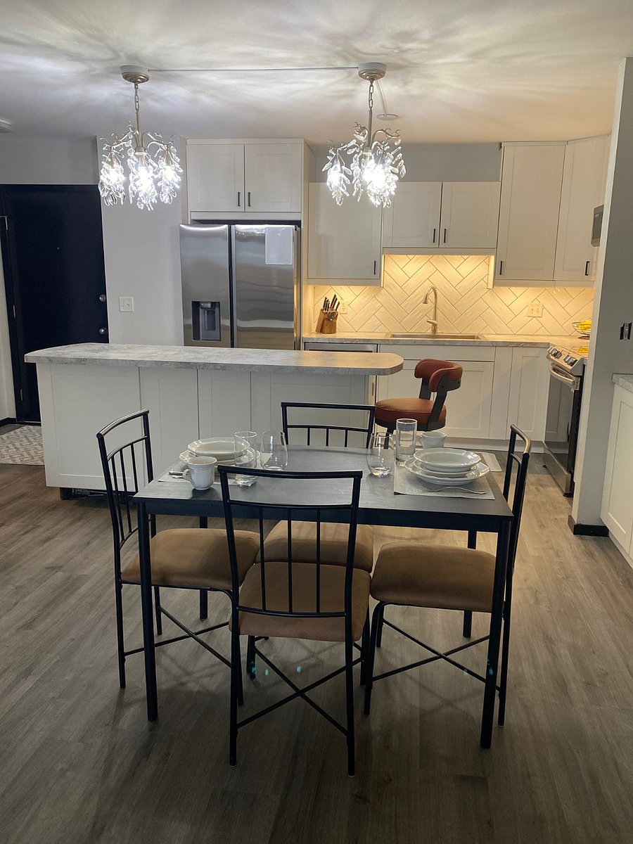 The kitchen offers sit-down dining. Behind the table, notice there is a comfy counter stool and space at the island to sit, enjoy coffee, or look at your computer.