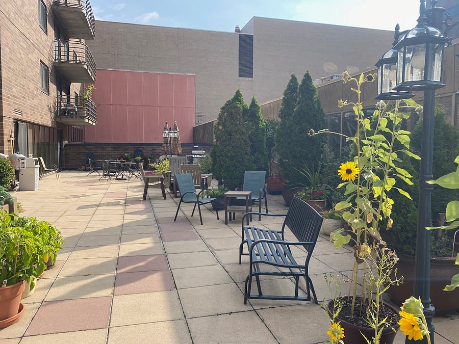 The condo building offers a large patio area for outdoor relaxation/social/gathering space.