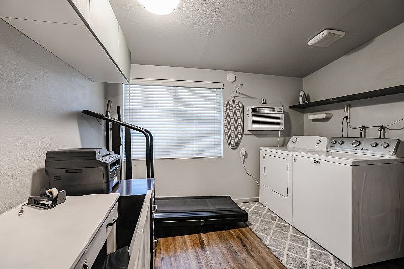 Utility Room With Full Size Washer And Dryer - Room Has Additional Mounted Air Conditioner To Ensure It Stays Nice And Cool. 