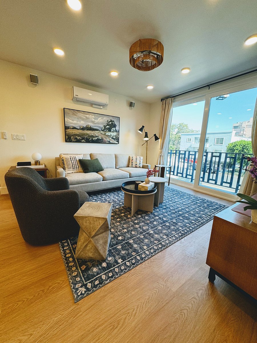 Swivel Chair & 4 person sofa w/ Sonos speakers mounted to the ceilingCo