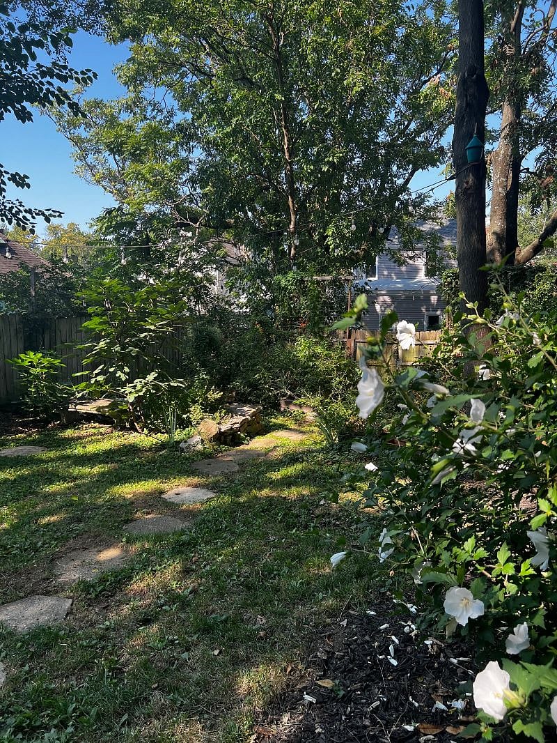 Relax in the private backyard garden with lots of shade and native plants galore.
