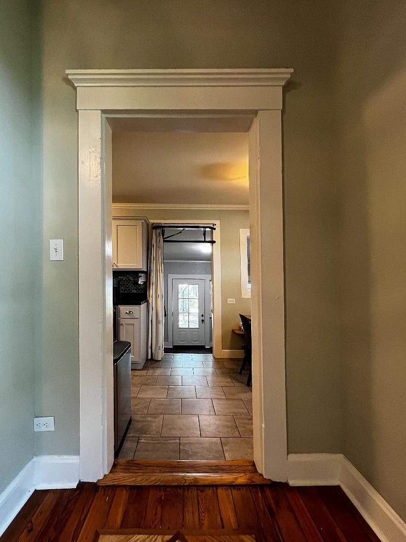 View from office into the kitchen/dining area towards the utility room and backyard.