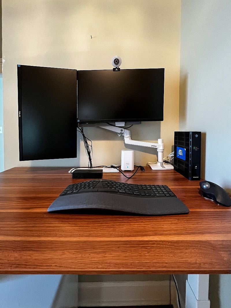 Ergonomic desk setup with wireless keyboard & mouse and dual monitors.