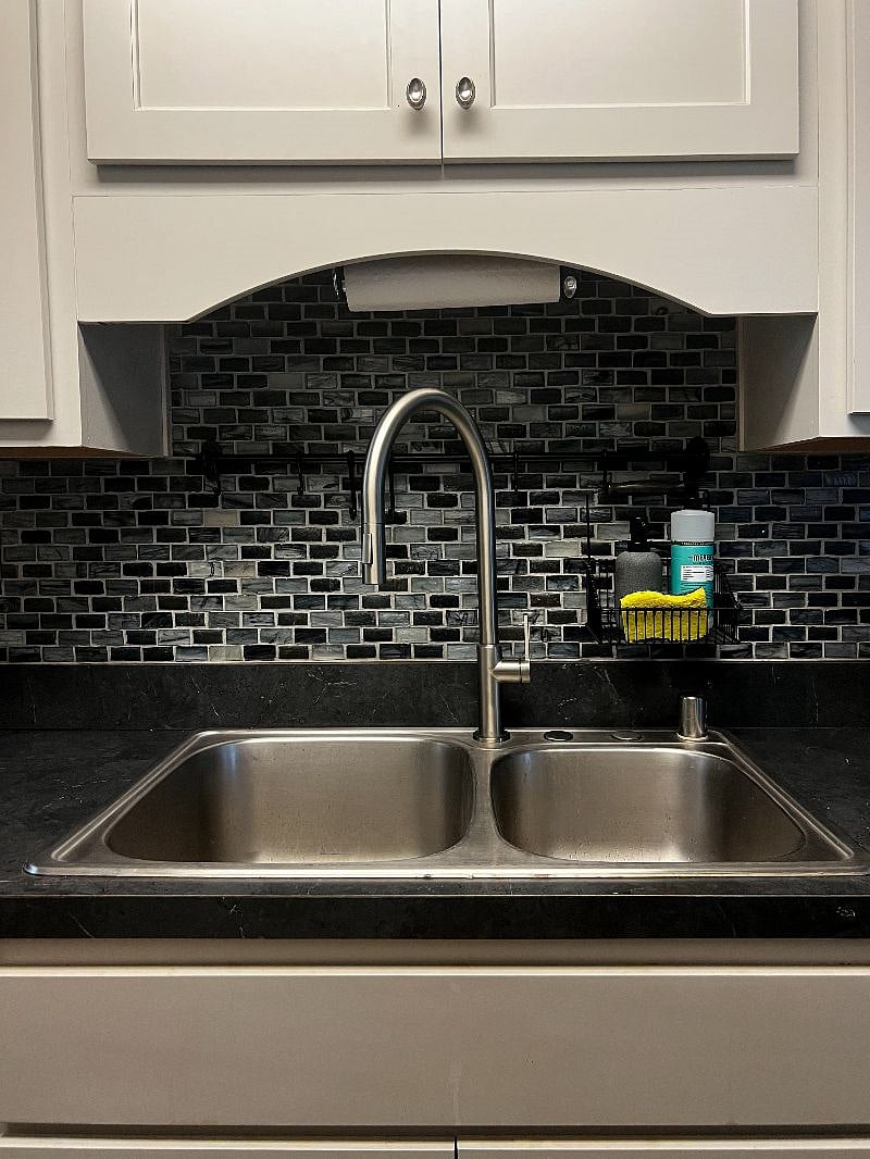 Dual-basin sink with garbage disposal.