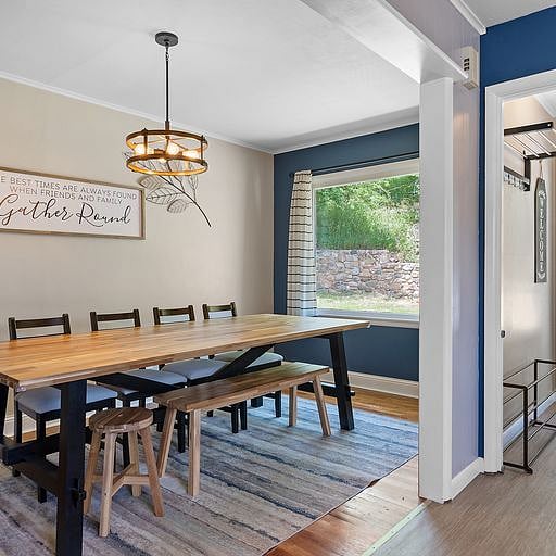 Adjacent to the kitchen is a large dining table, perfect for enjoying meals, working from home, or planning your day.