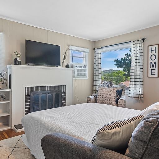 Unwind by the fireplace on a plush, comfortable sofa, perfect for curling up with a book, streaming your favorite shows, or enjoying some downtime.