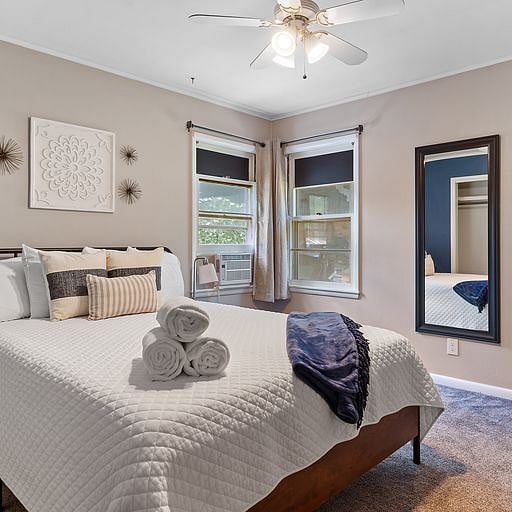 Bedroom 2 with Queen bed, premium sheets, pillows, luxurious towels, nightstand with light, mirror