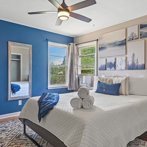 The master bedroom features a plush queen bed with soft, high-quality cotton linens, ensuring a restful nights sleep after a long day at work.