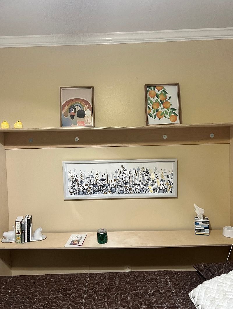 Shelf area by Murphy wall bed in large bedroom.