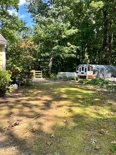 View of backyard upon entering through main gate. Chicken coop seen in the distance.