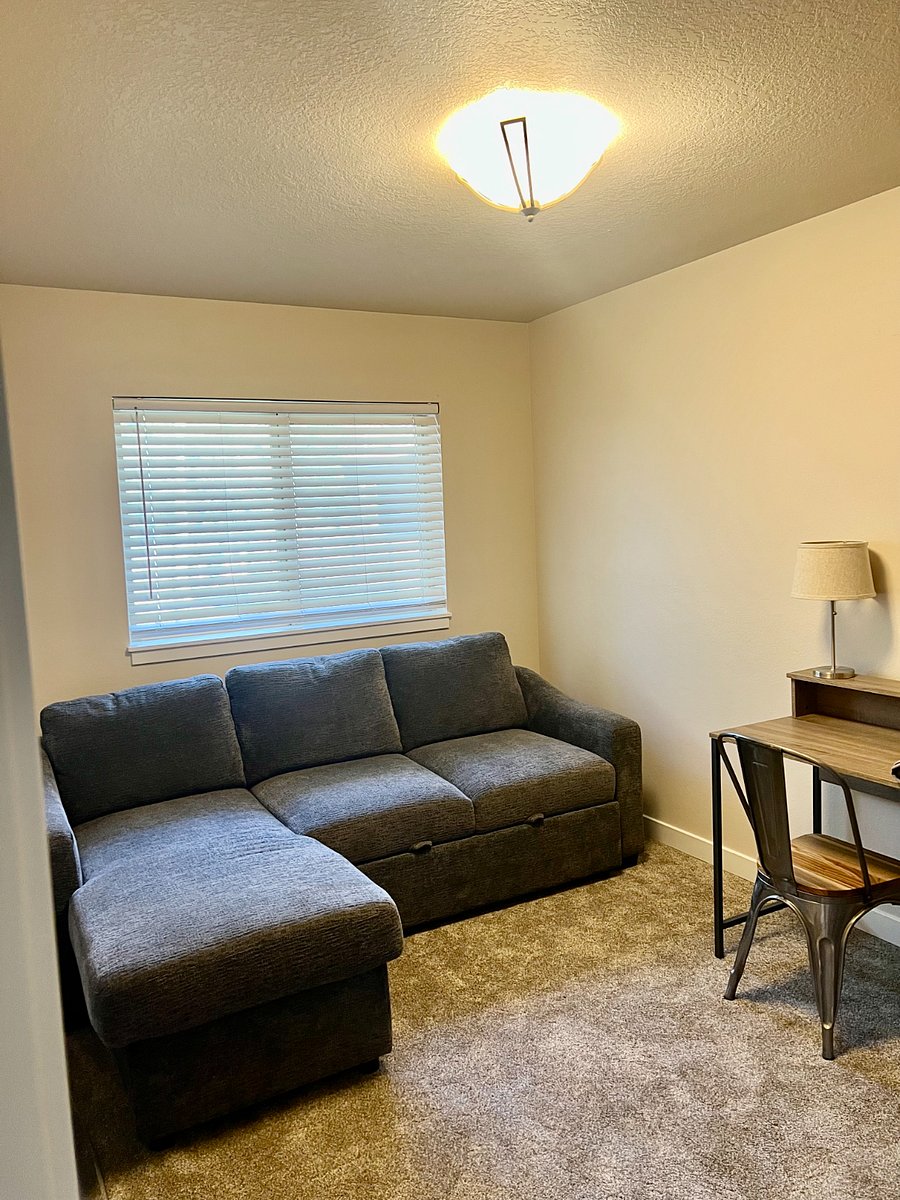2nd bedroom with desk and sectional that opens to full bed.