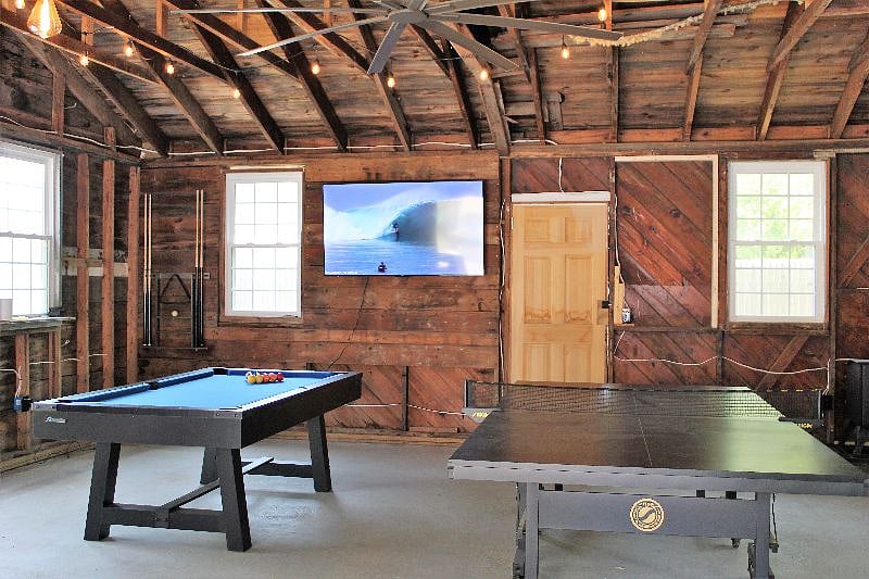 Exterior game room with pool table, ping pong, darts and seating.  4 cruising bikes also available for use.