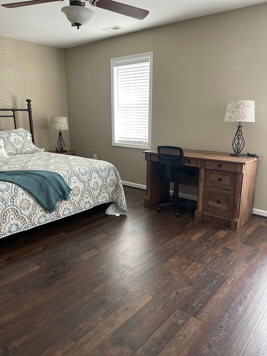Bedroom two outfitted with work space and king bed.  Large bright bedroom with ceiling fan double closets and situated next door to the hall bath.