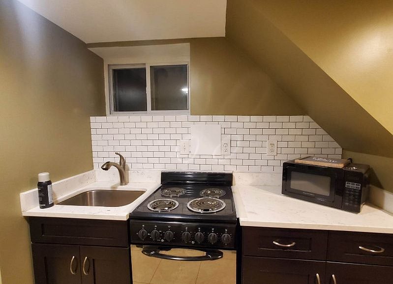 Full kitchen equipped with electric stove/oven, microwave and full sized fridge.