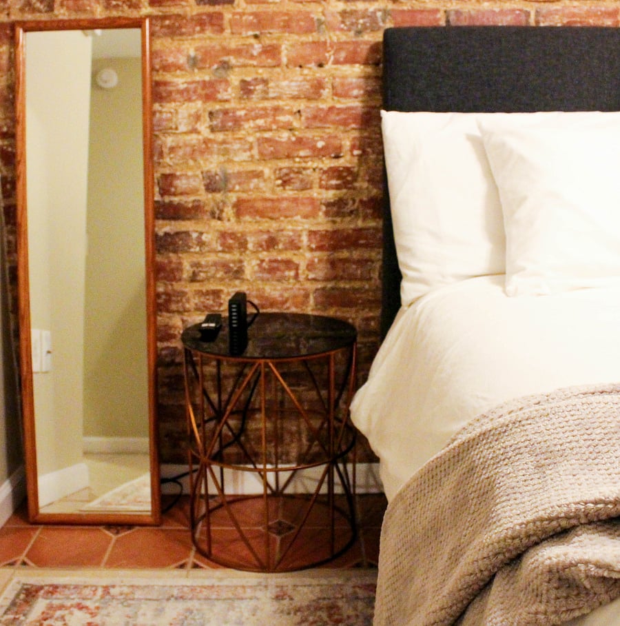 nightstand and mirror in bedroom