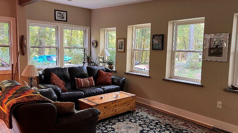 Living room with view toward parking and entry on deck.