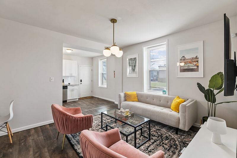 The spacious lounge area boasts plenty of seating for guests to relax and spend quality time together, while a large window behind the sofa lets in lots of natural light.