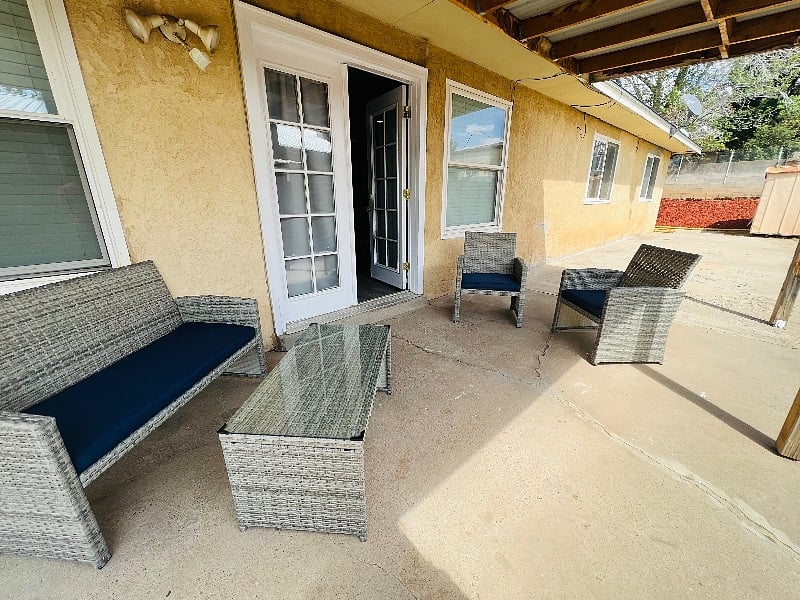 Side entrance with beautiful new patio set and lights.