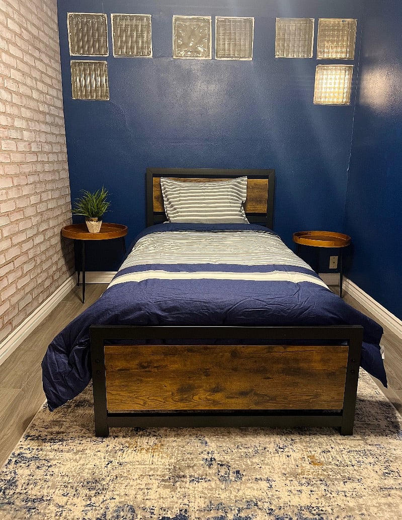 Third bedroom with twin-size mattress and white board.