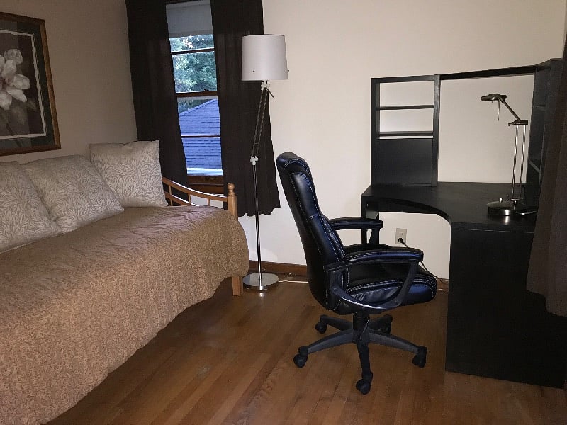 Bedroom furnished as an office also has a comfortable daybed and small dresser. This room opens onto the deck.