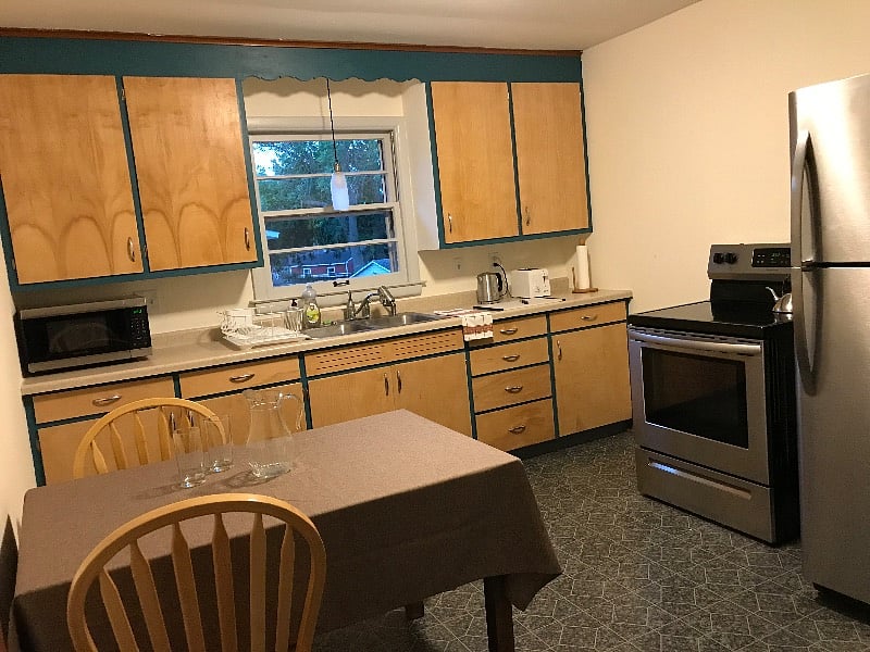 Original mid century kitchen with modern stainless steel appliances. Fully equipped with dishes and utensils.