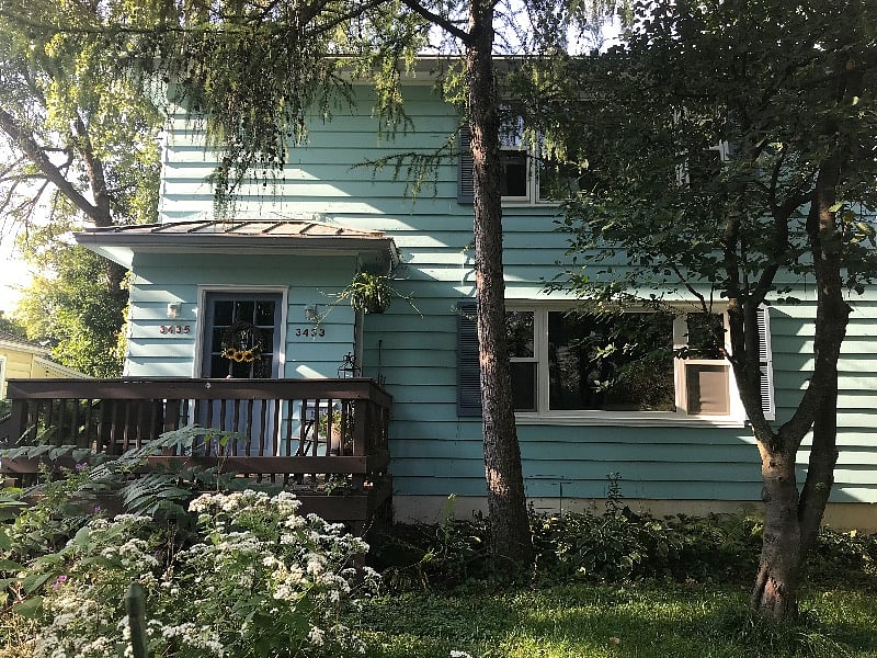 Front door opens into a hall with stairway to the apartment and door to lower unit. There is also a stairway here to the basement with washer and dryer, and a lockable storage closet.