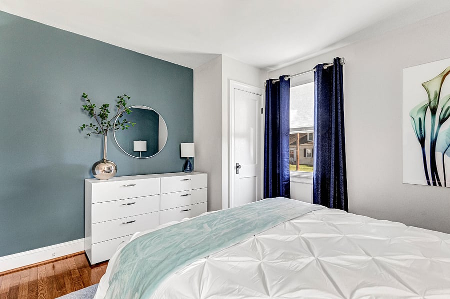 Ample clothing storage with full dresser, closet space, and blackout curtains for a restful night's sleep.