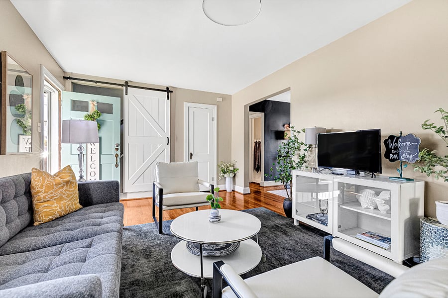 The cozy living room opens up to the dining room and features a Smart TV with streaming capabilities.