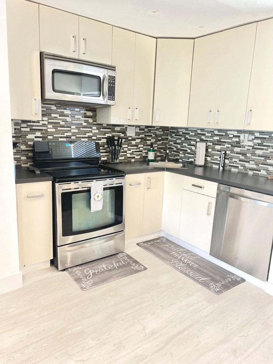 Full size kitchen with oven, glass stove top, microwave, air fryer, kuerig, rice cooker