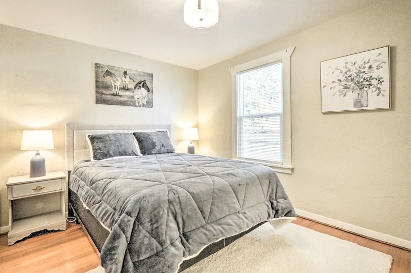 Main bedroom with queen bed, small closet to left of bed, and walk in across from bed.