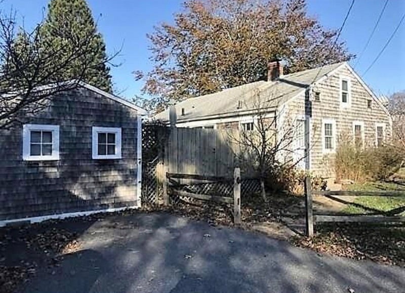 Driveway, tool shed and street side view looking at side door.