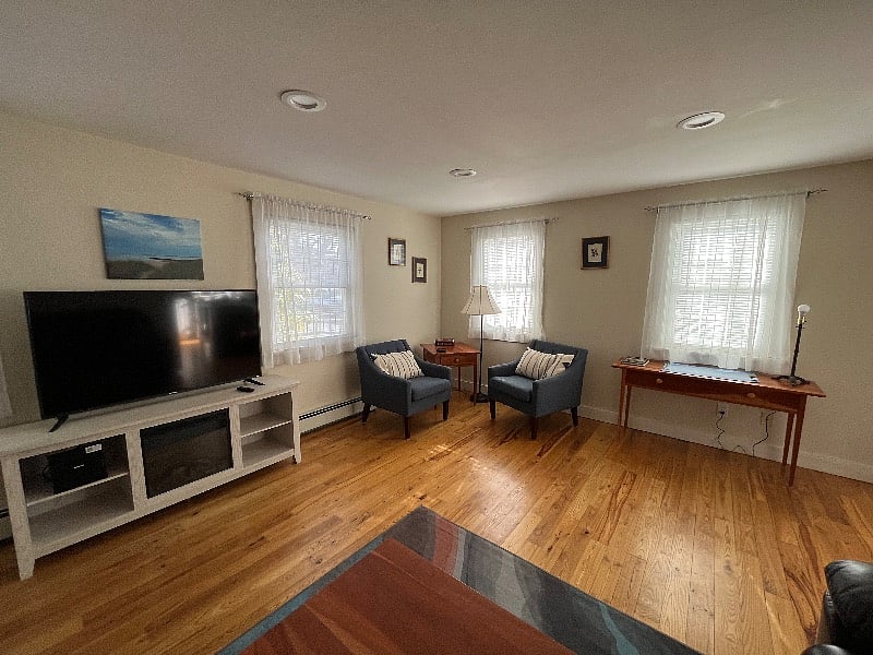 View of living area from bedrooms hallway. Electric fireplace TV stand.