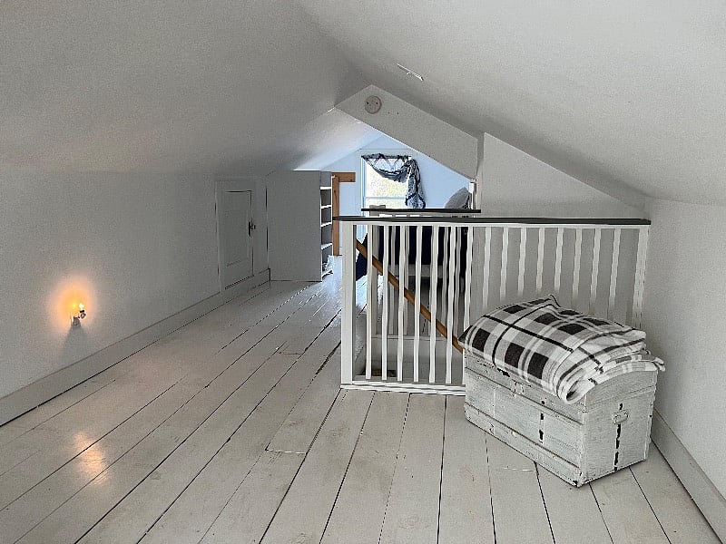 Attic looking toward twin bed side and stairs to foyer.