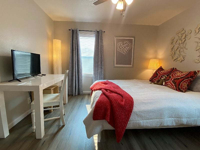 Bedroom 2- Red Room.   Queen memory foam bed, closet, ceiling fan, independently controlled heat/cool, desk/vanity, LVT Flooring, Smart Roku TV, Private Bedroom door Keypad Lock