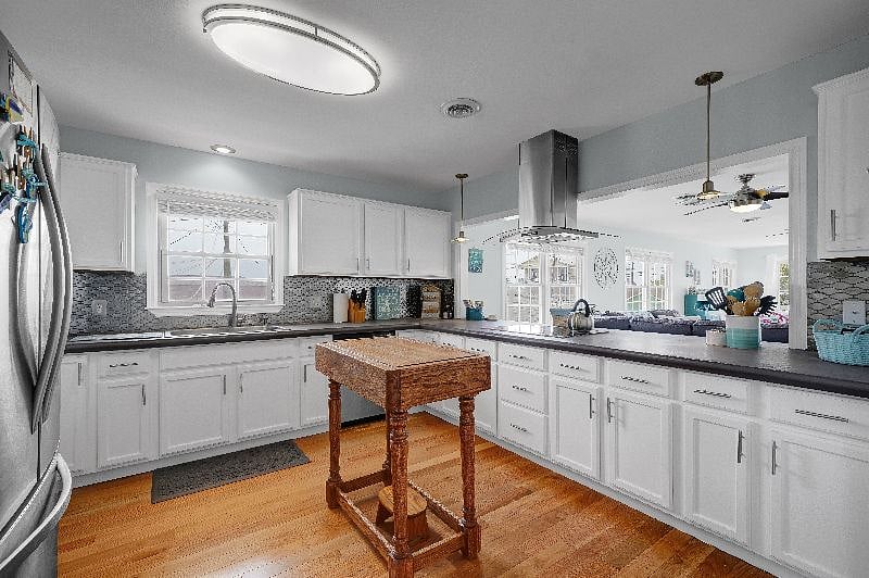 Large kitchen has full sized refrigerator with icemaker, dishwasher, electric oven, electric
stovetop and prep island.