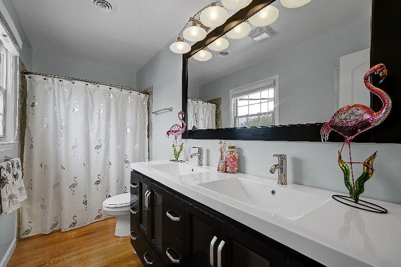 Hall bathroom has shower/tub combination and double sinks.