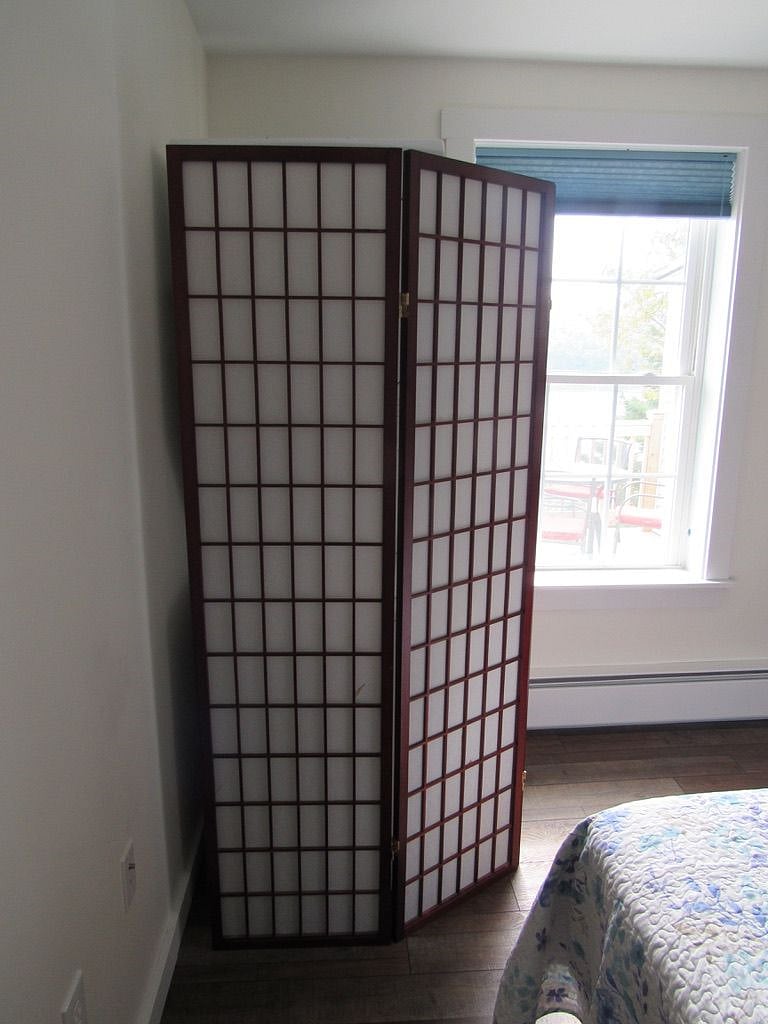 Shoji screen hiding the washer & dryer in bedroom