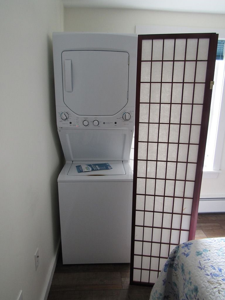 Washer & dryer in bedroom w/ shoji screen pulled back