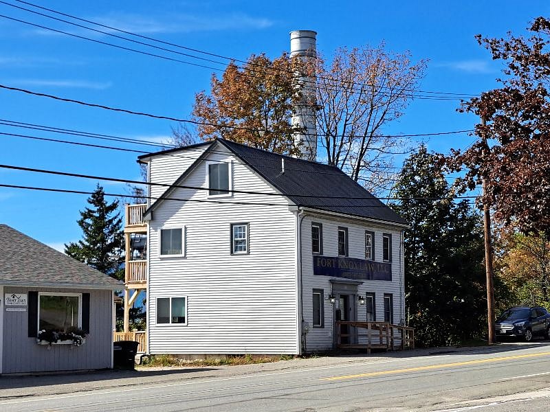 Front of 140 Main St. Parking to the left of the building.