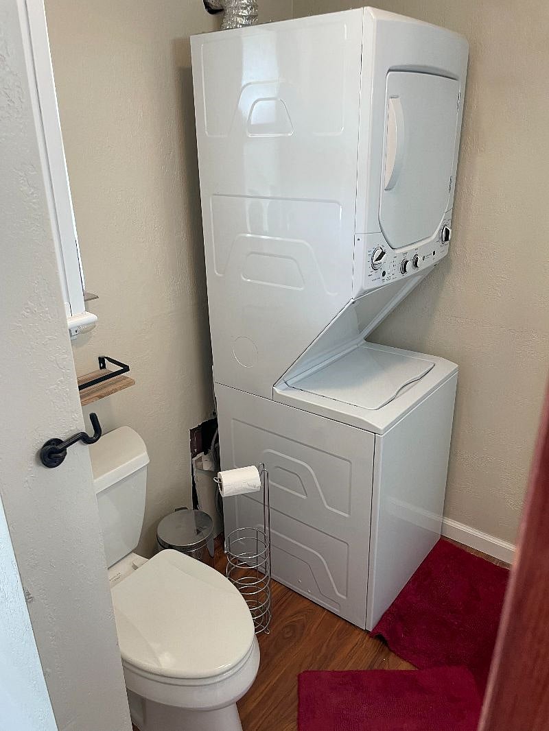 Stacked washer/dryer located in bathroom.