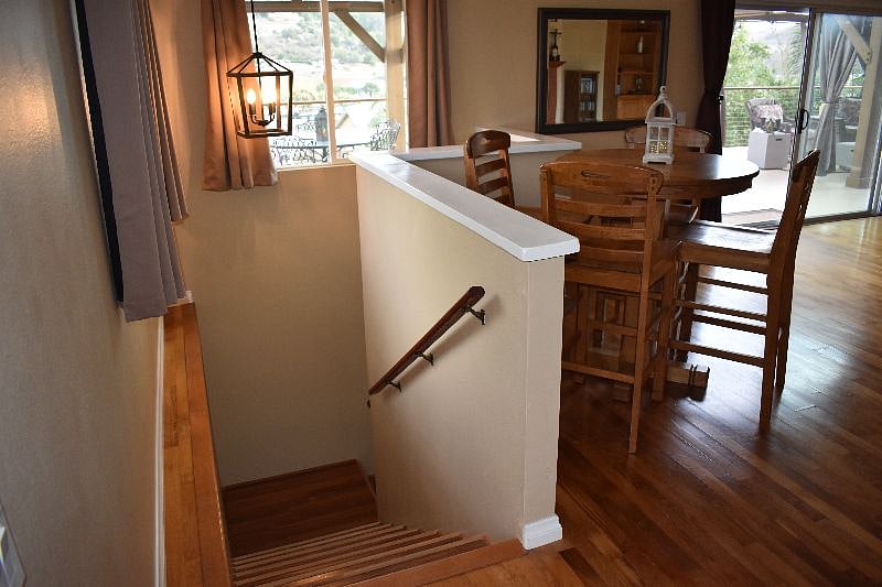 Stairs leading to lower level: bedroom, kitchen, bathroom, second living room area.