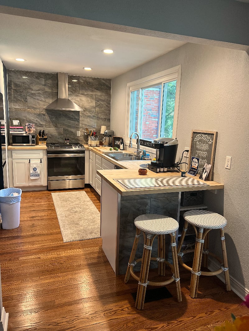 remodeled kitchen small but very efficient butcher block counters, white shake cabinets and fabulous tile.