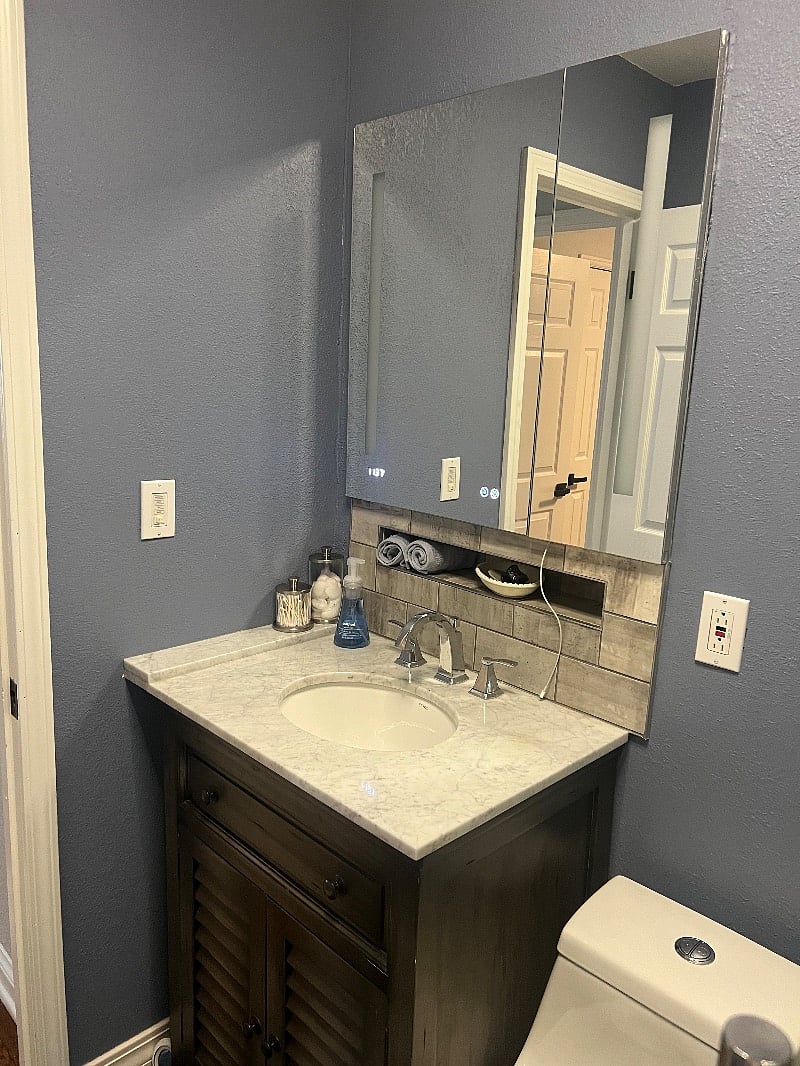 1st floor bath remodeled with beautiful tile and large mirror opens for storage