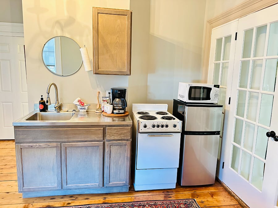 kitchen is stocked with pots and pans and essential cooking utensils 